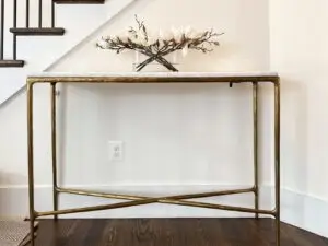Designer child proofing on an entry table with tip resistant furniture tethers.