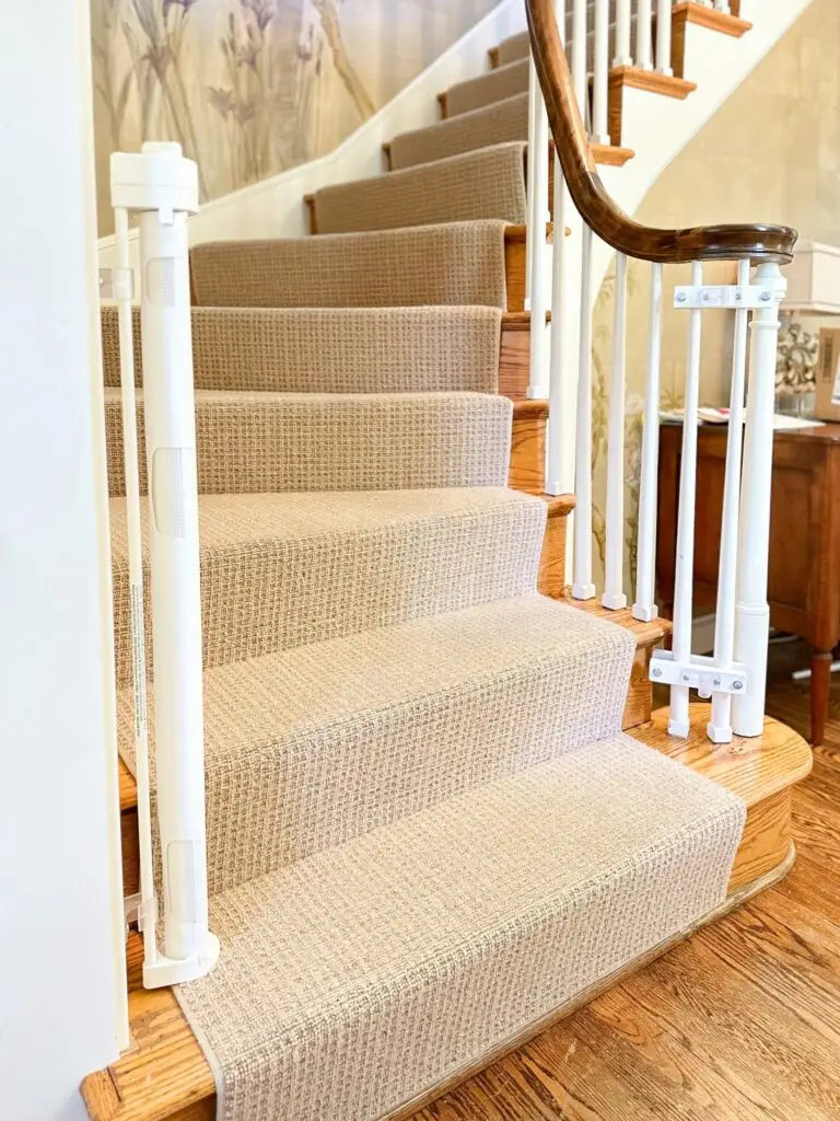 Carpeted staircase with safety gate