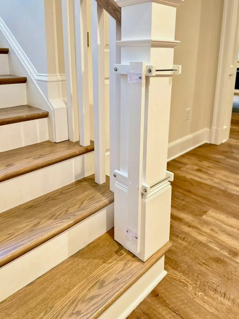 Close up of oversized post clamp on basement stairs going up.