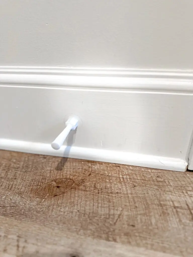 Child safe door stop installed on trim.