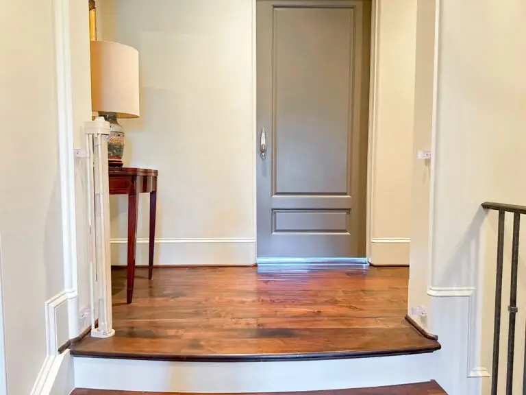 Welcoming entrance with wooden flooring and open retractable gate
