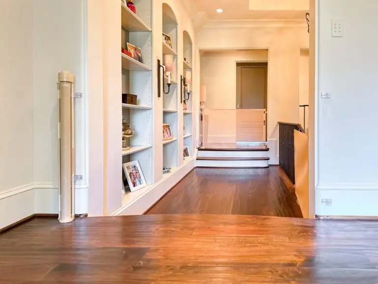 Spacious hallway with shelves and stairs and retractable gates