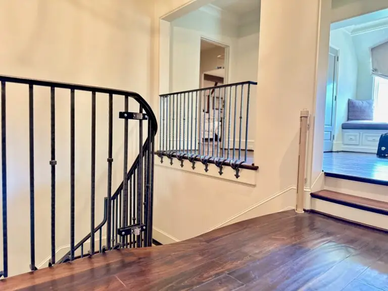 Elegant staircase with modern railing and retractable gate
