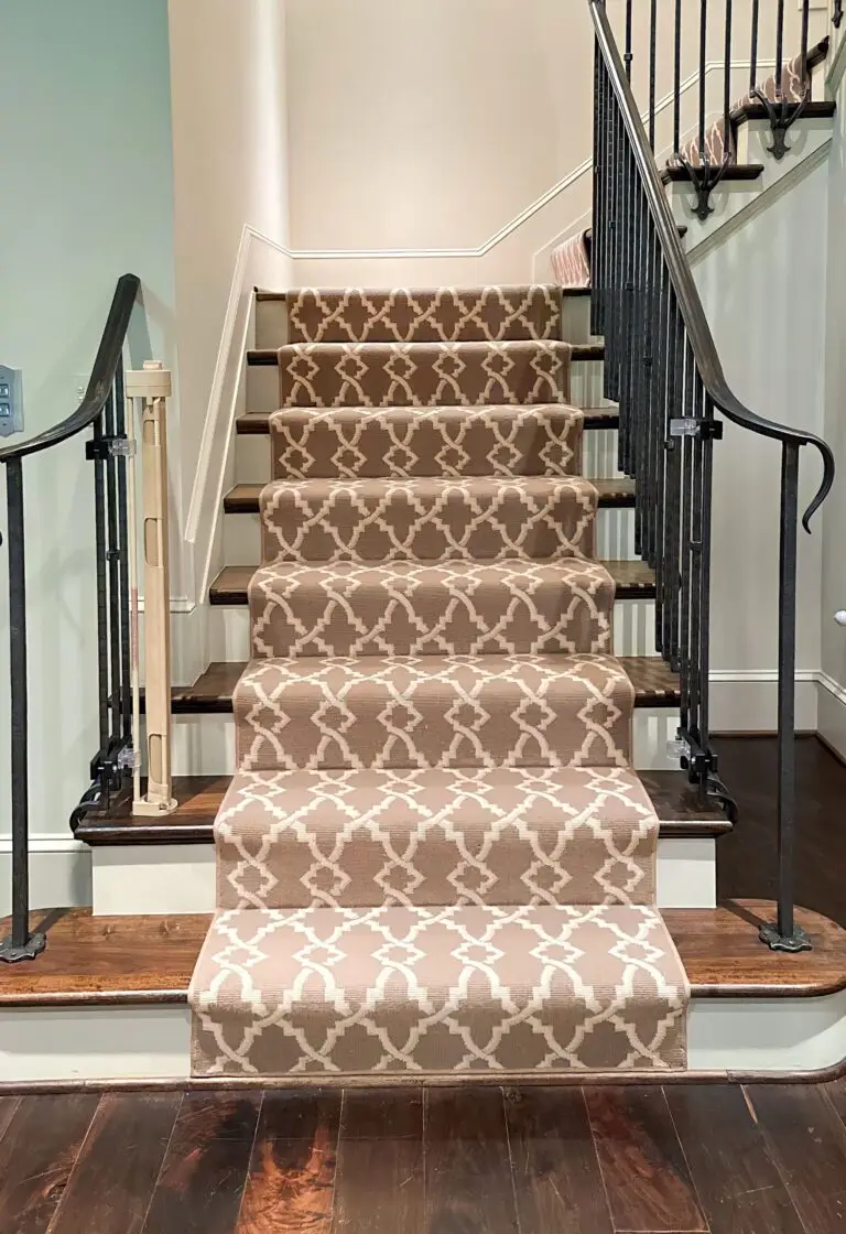 Elegant staircase with patterned carpet and cafe retractable gate