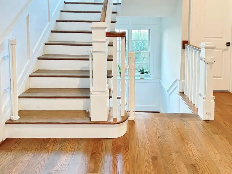 Retractable gates, open, installed in foyer of home with custom post mounts.