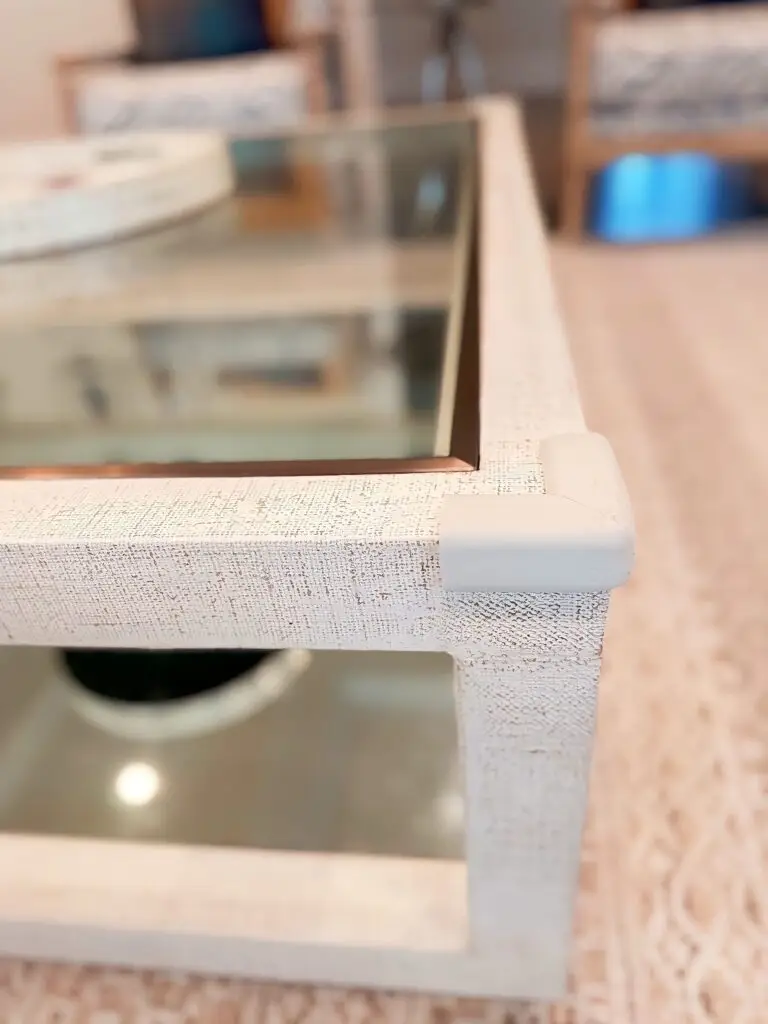 Ivory corner cushion installed on coffee table in living room.