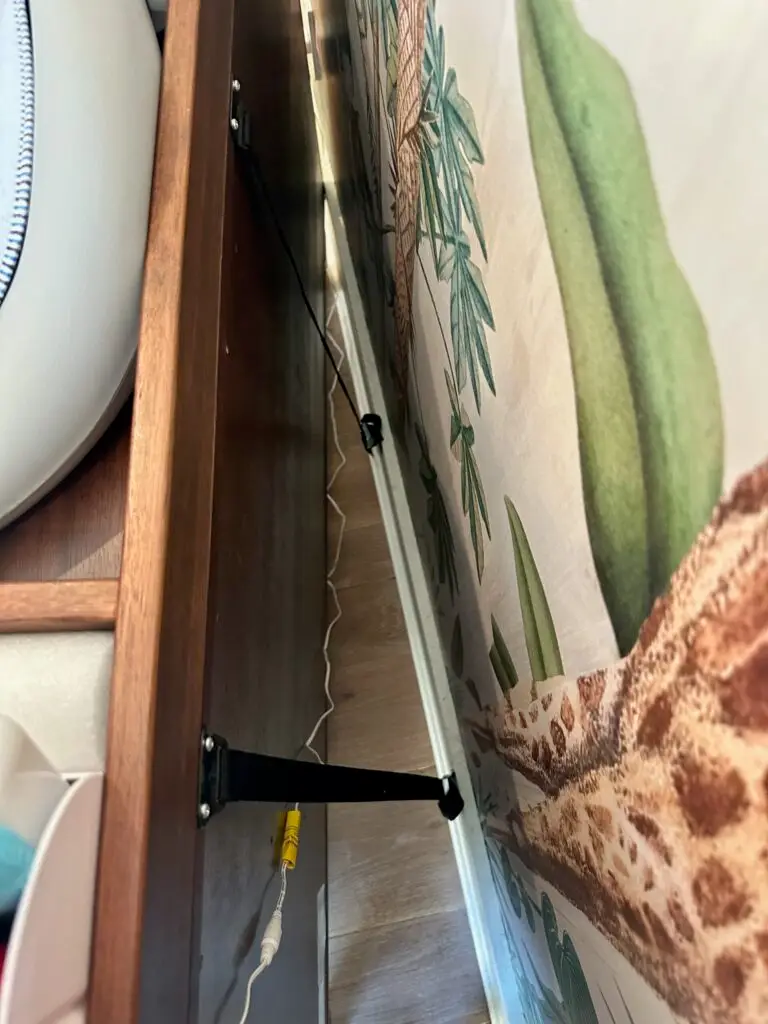 Wooden furniture secured to decorative wall