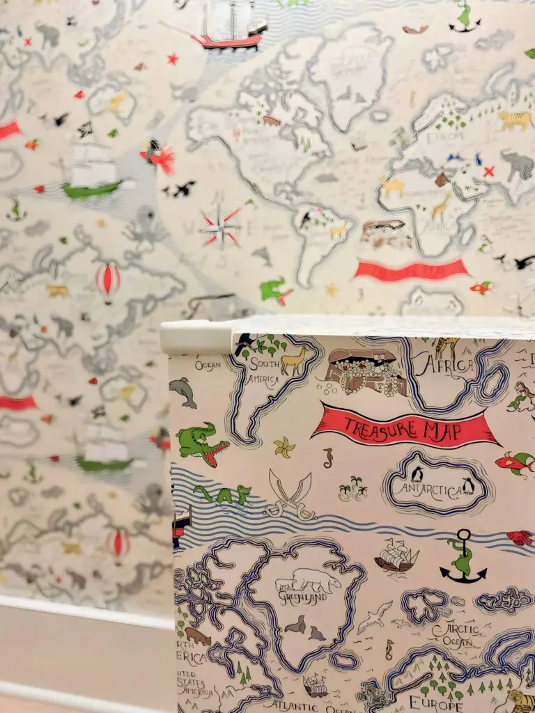 Colorful treasure map wallpaper design and ivory corner cushion