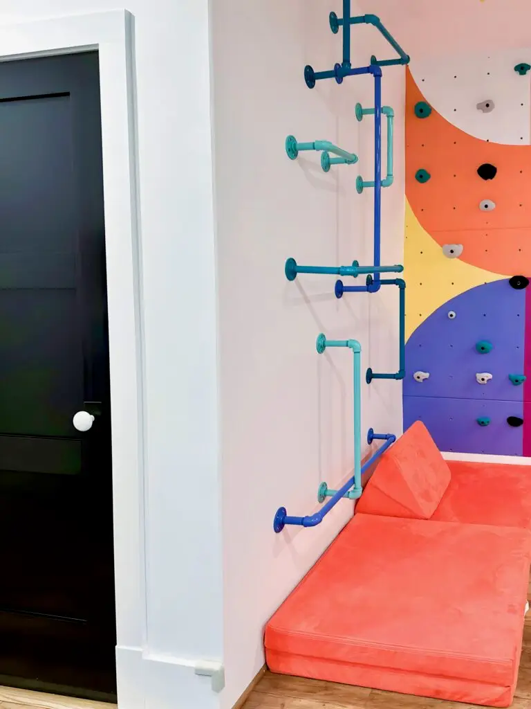 Colorful climbing wall with orange couch