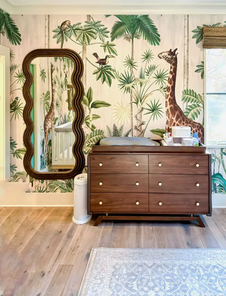Tropical nursery with giraffe wallpaper.