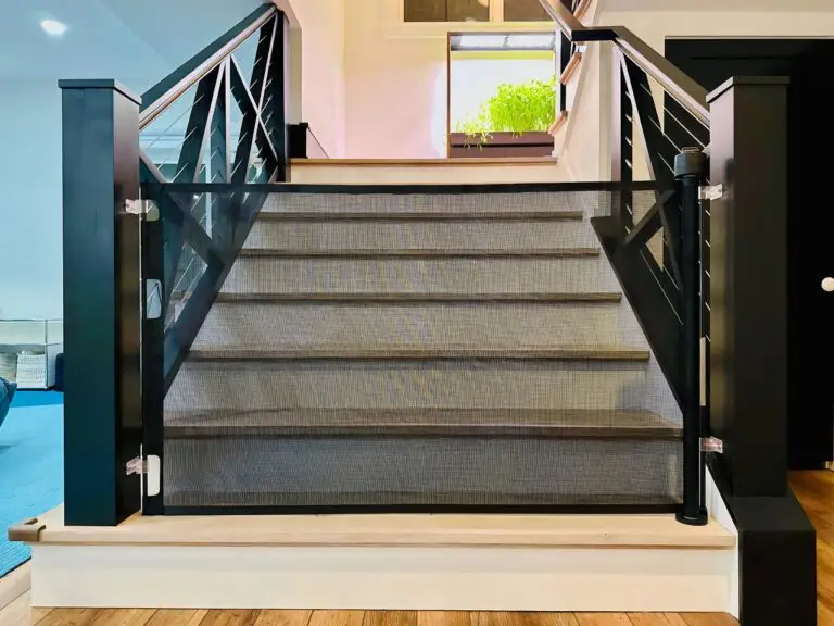 Staircase with black safety gate installed