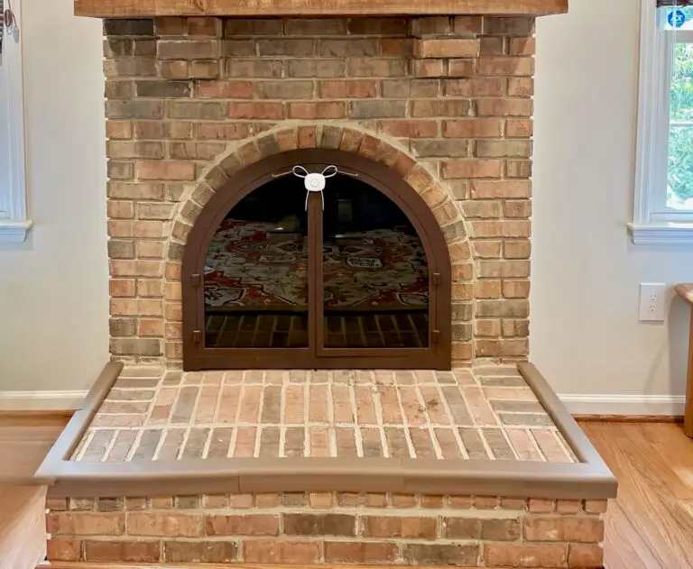 Brick fireplace with glass doors with hearth padding and a dual flex lock