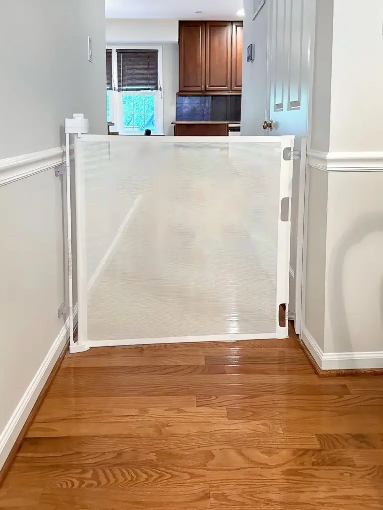 White retractable gate blocking off kitchen