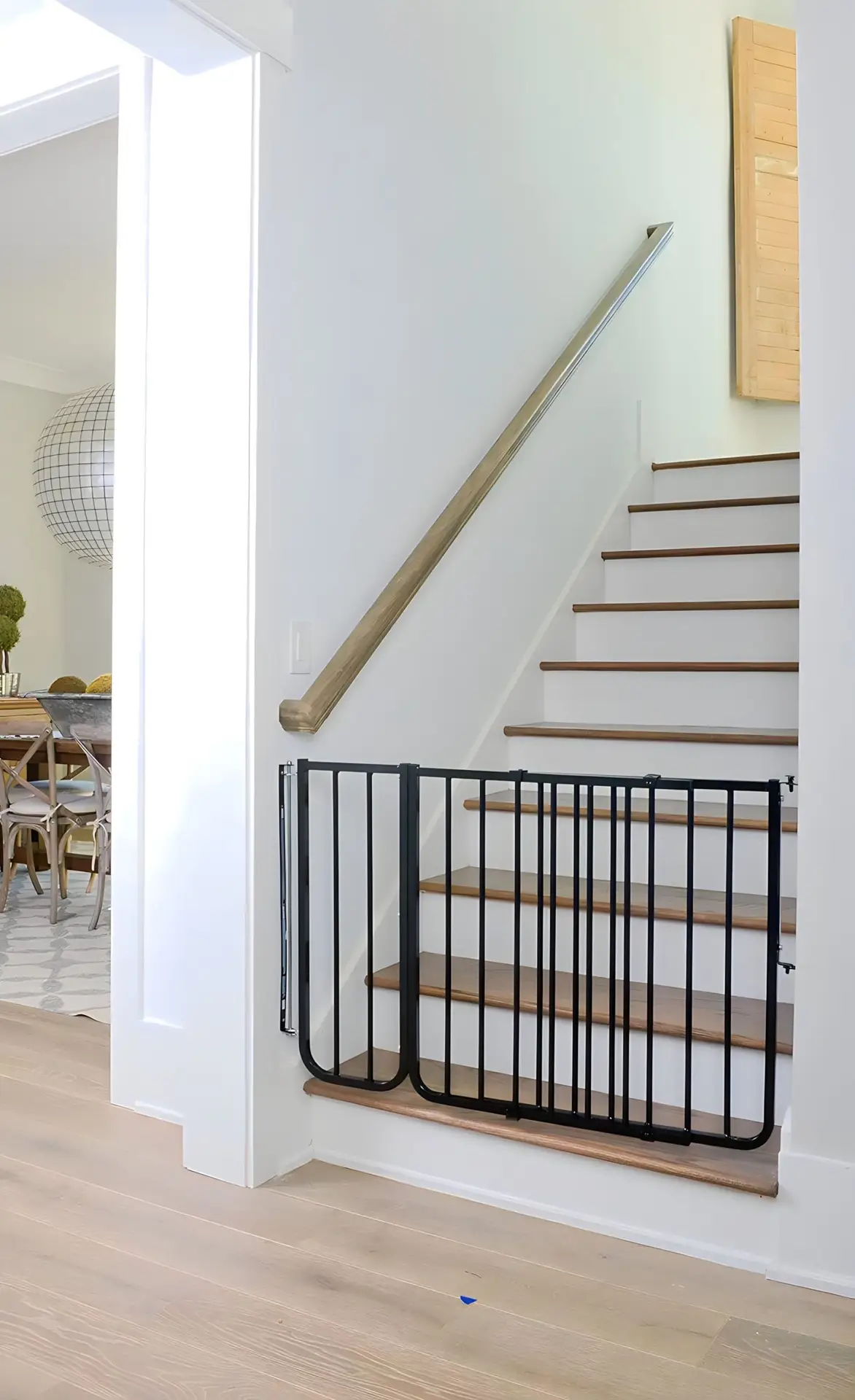 Baby gate installation on staircase with black safety gate