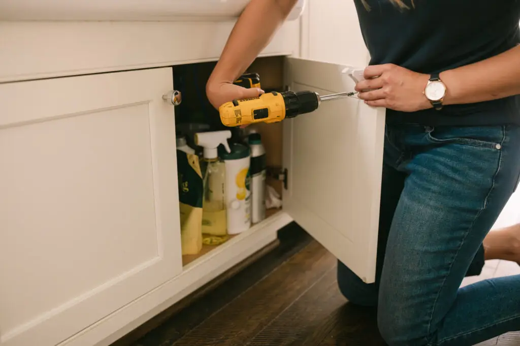Beyond the Hype: Trustworthy Baby Proofing 1 Baby proofer installing magnet locks