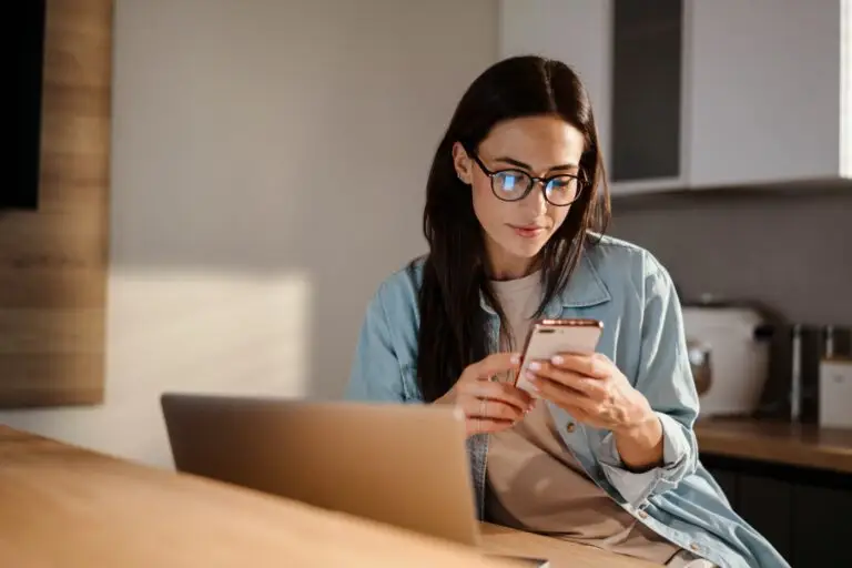 Mother looking at computer and deciding on professional baby proofing or DIY