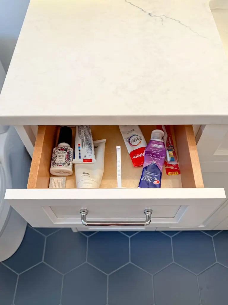 Bathroom vanity drawer fitted with a drawer latch, shown open