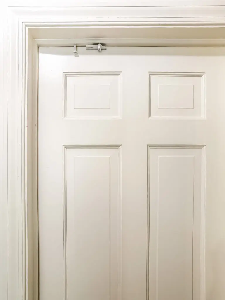Close-up of a top door lock installed above a six-panel door
