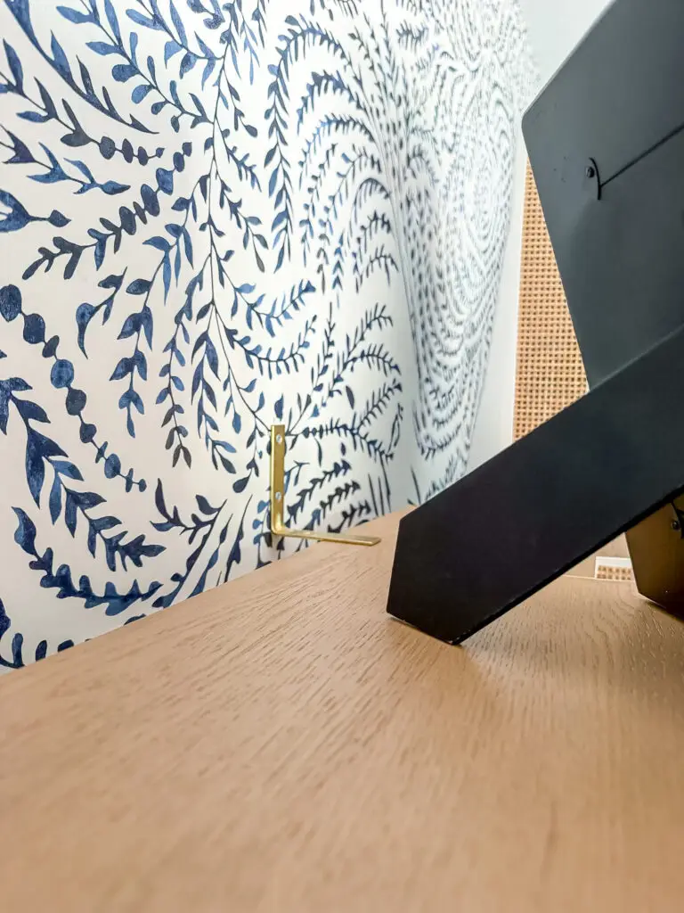 Furniture bracket securing the office bookshelf to the wall