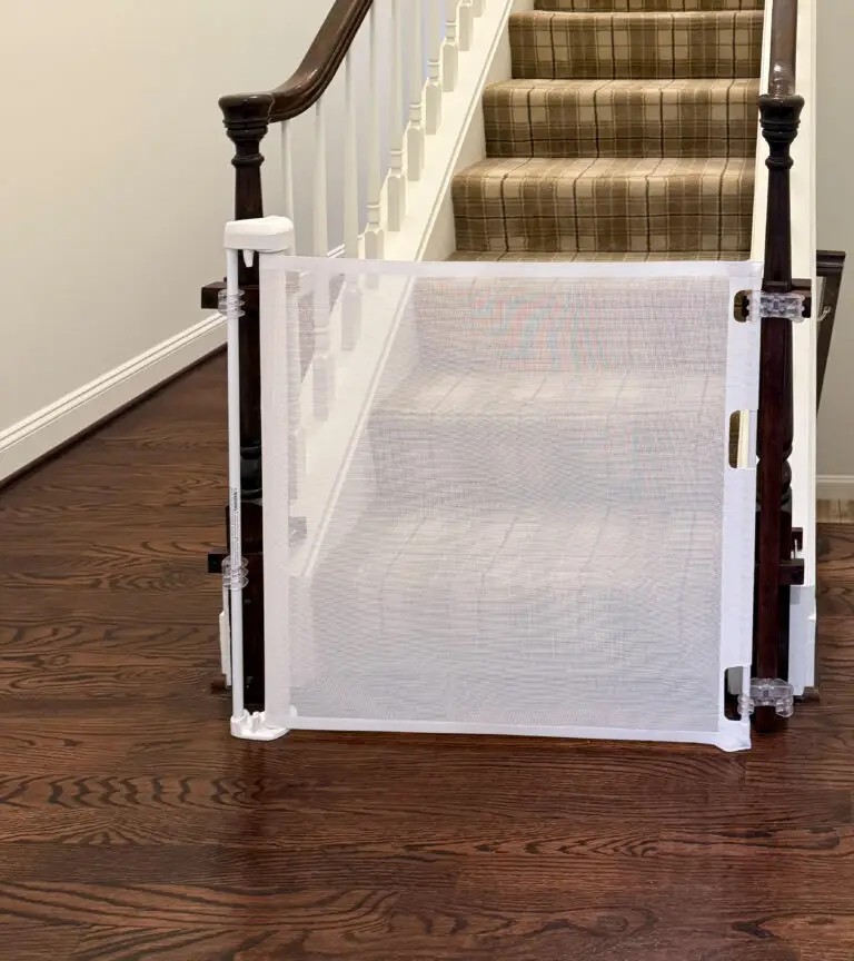 White retractable gate closed at the bottom of the carpeted stairs to the third floor in a maryland home