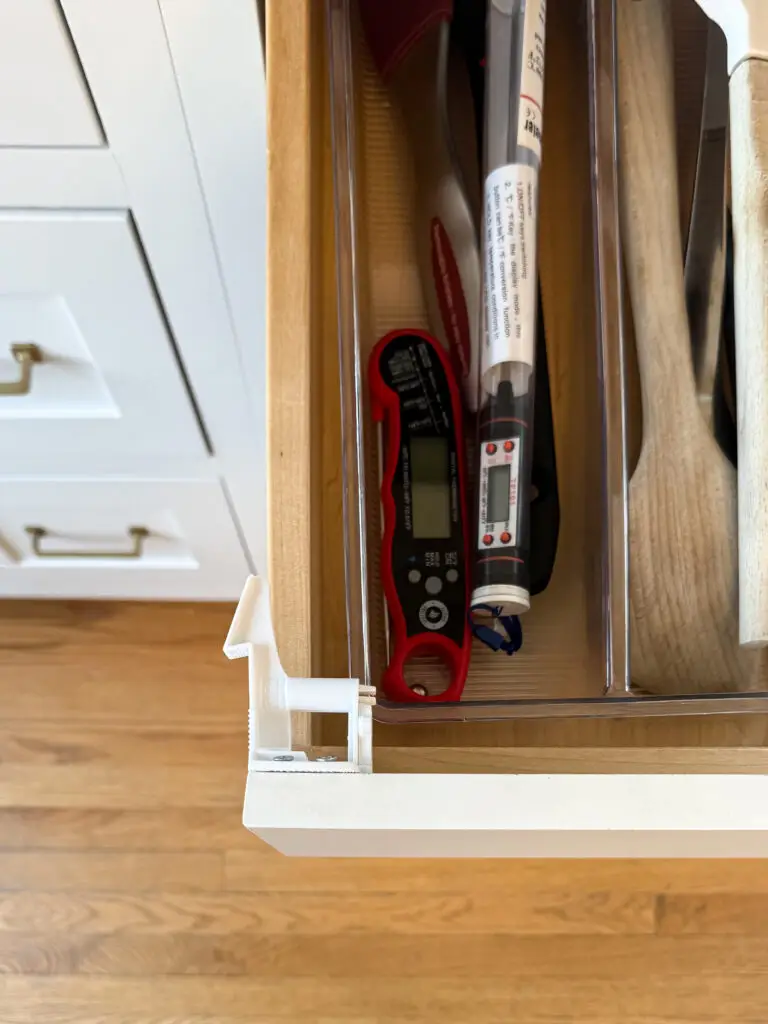 Drawer latch installed inside a kitchen drawer