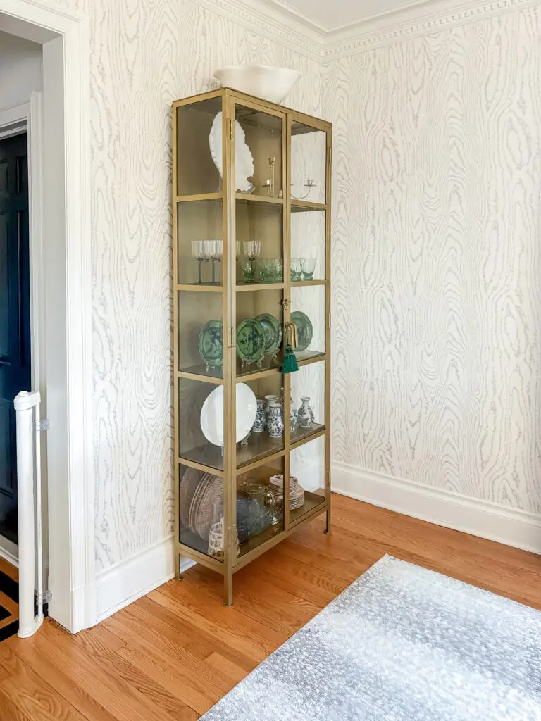 Glass display cabinet anchored with anti-tip tethers in a palisades, dc dining room