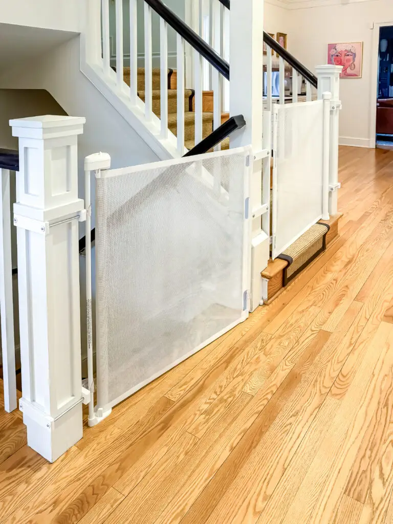 White retractable gate at the bottom of the main staircase, mounted to the newel post, in a palisades, dc home