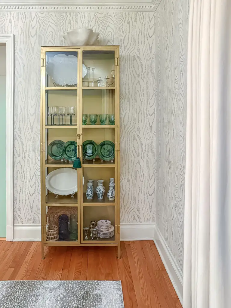 Anchored glass display cabinet of breakables beside a doorway in a washington, dc home