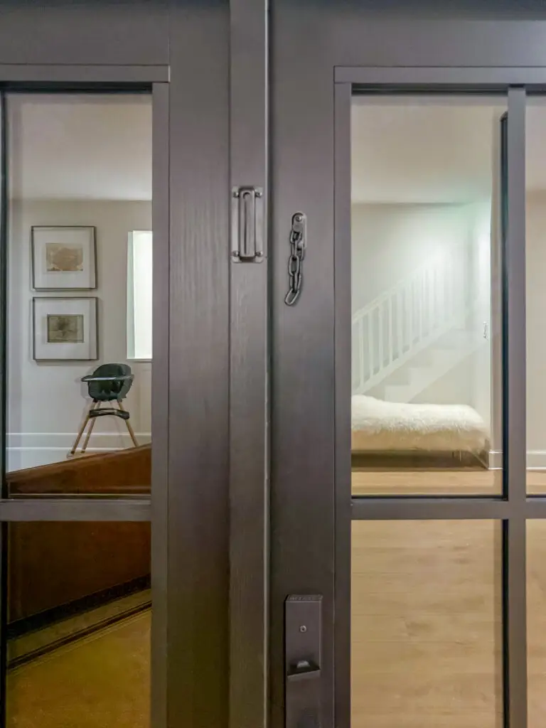 Black chain lock installed on a glass-paneled exterior door in a washington, dc home