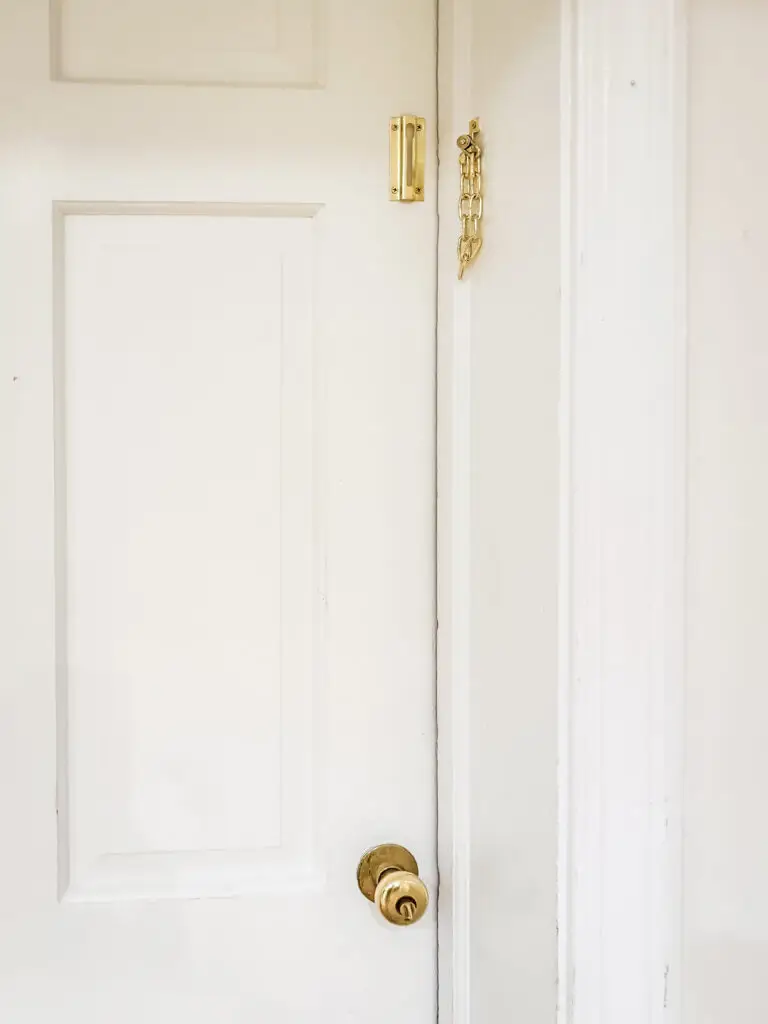 Brass chain door guard installed high on the garage door inside a palisades, dc home