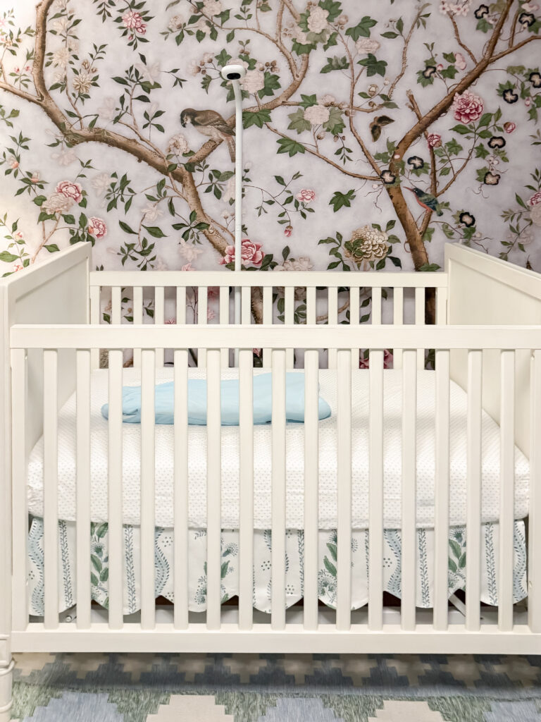 Baby monitor mounted on the nursery wall above the crib with its cord secured out of reach in a palisades, dc home