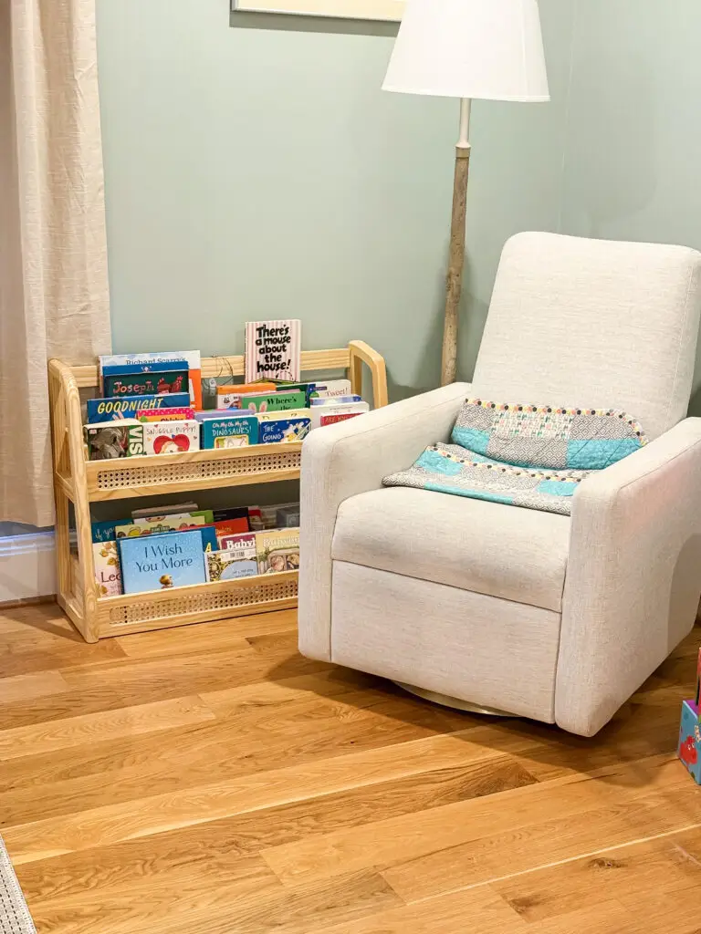 Nursery reading nook with a glider and book display in a bethesda, md home