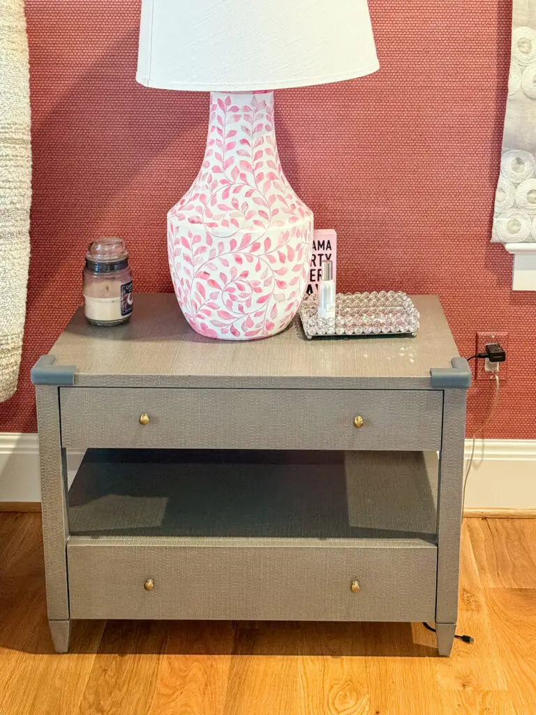 Nightstand with corner cushions on its top corners, anchored to the wall