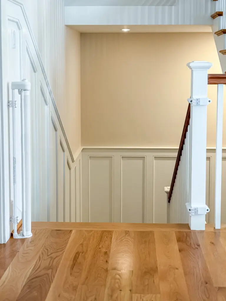 White retractable gate posts at the top of the basement stairs in a bethesda, md home
