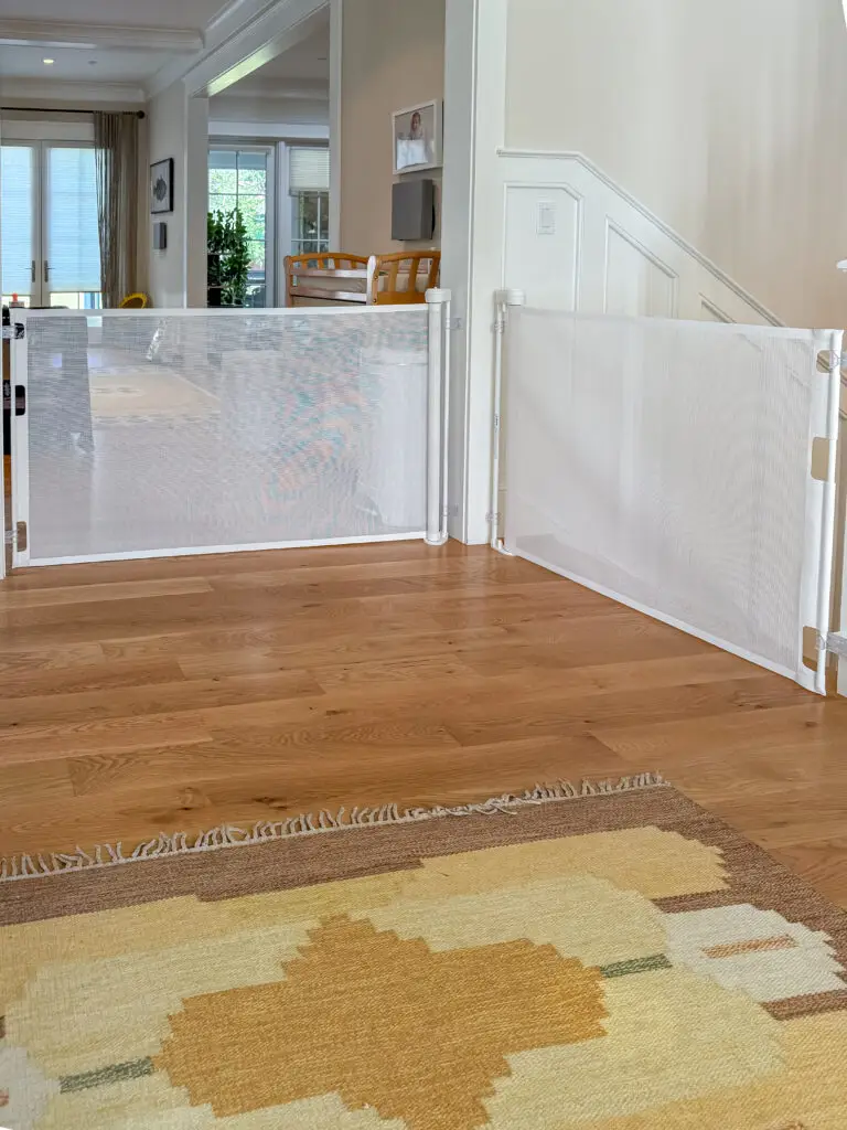 Two retractable mesh baby gates spanning wide openings in an open-plan maryland home