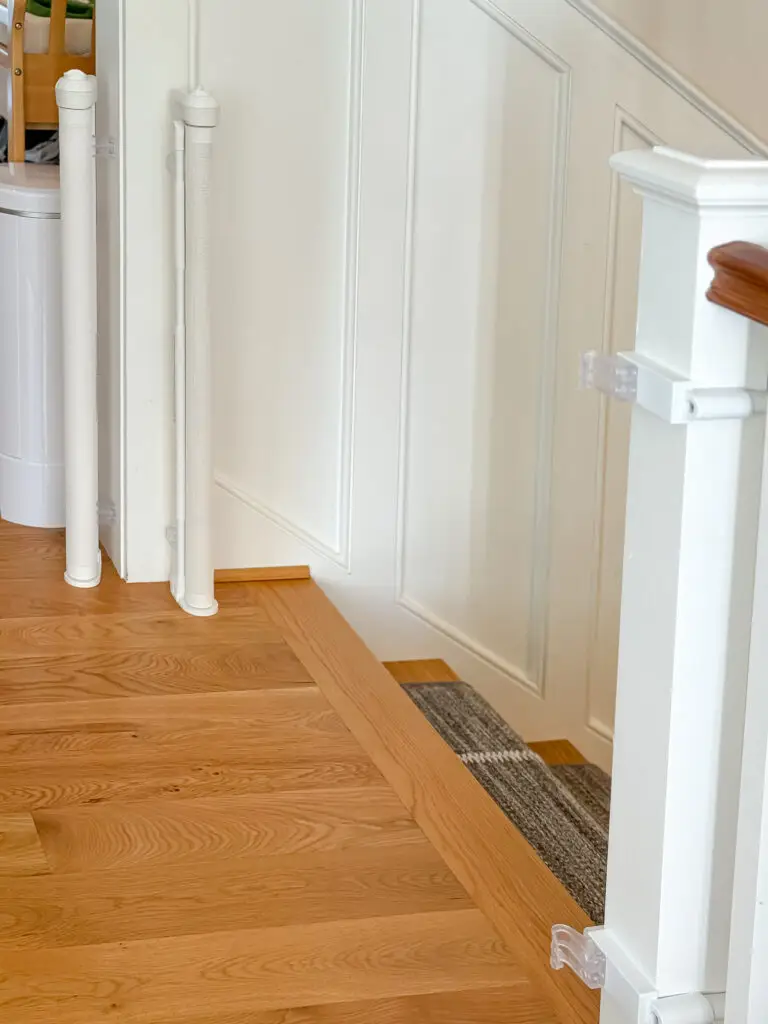 Retractable gate mounts on the newel post at the main-floor stairway opening