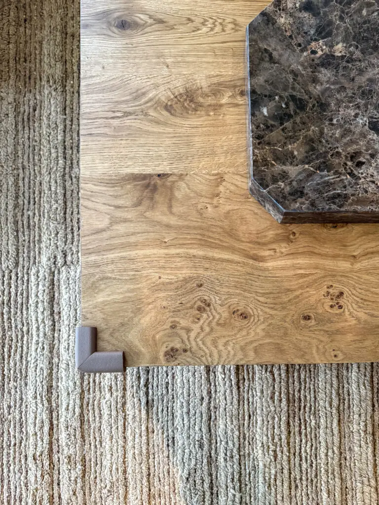 Close-up of a corner cushion on the edge of a wood coffee table