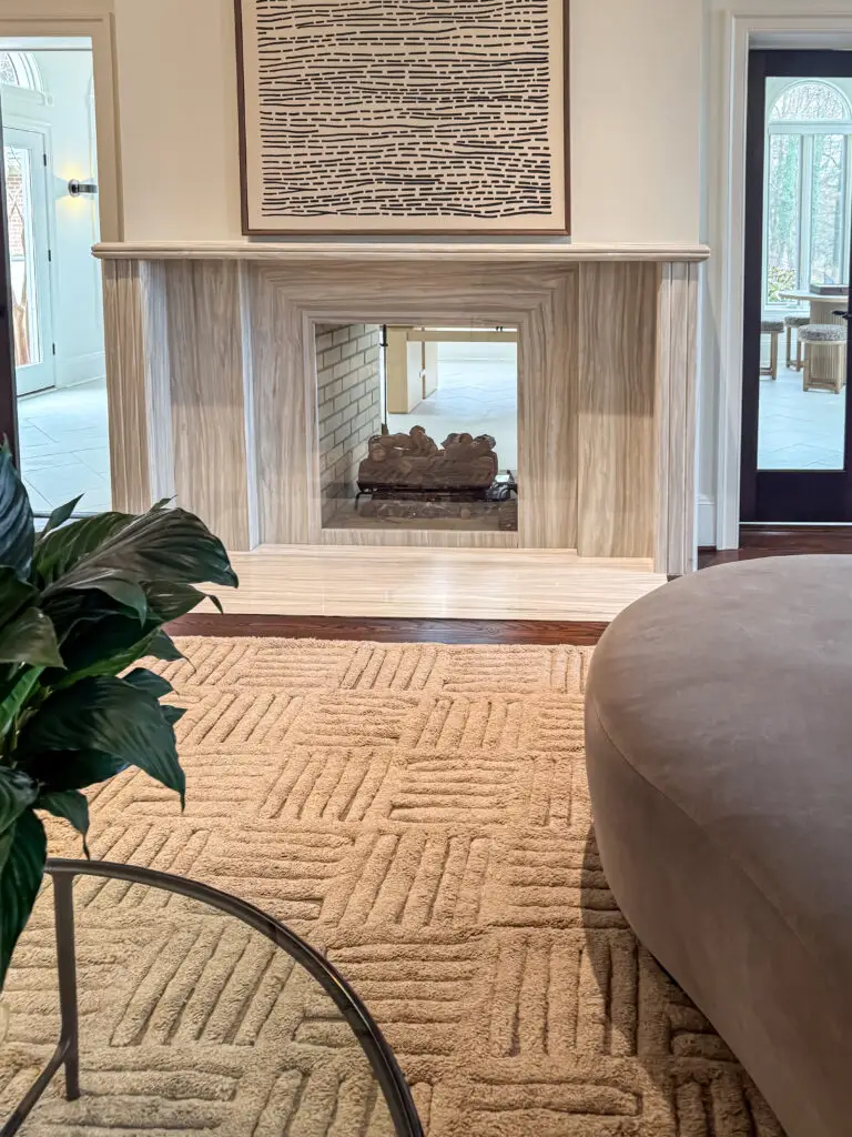 Double-sided stone fireplace in the formal living room covered with clear plexiglass in a maryland home