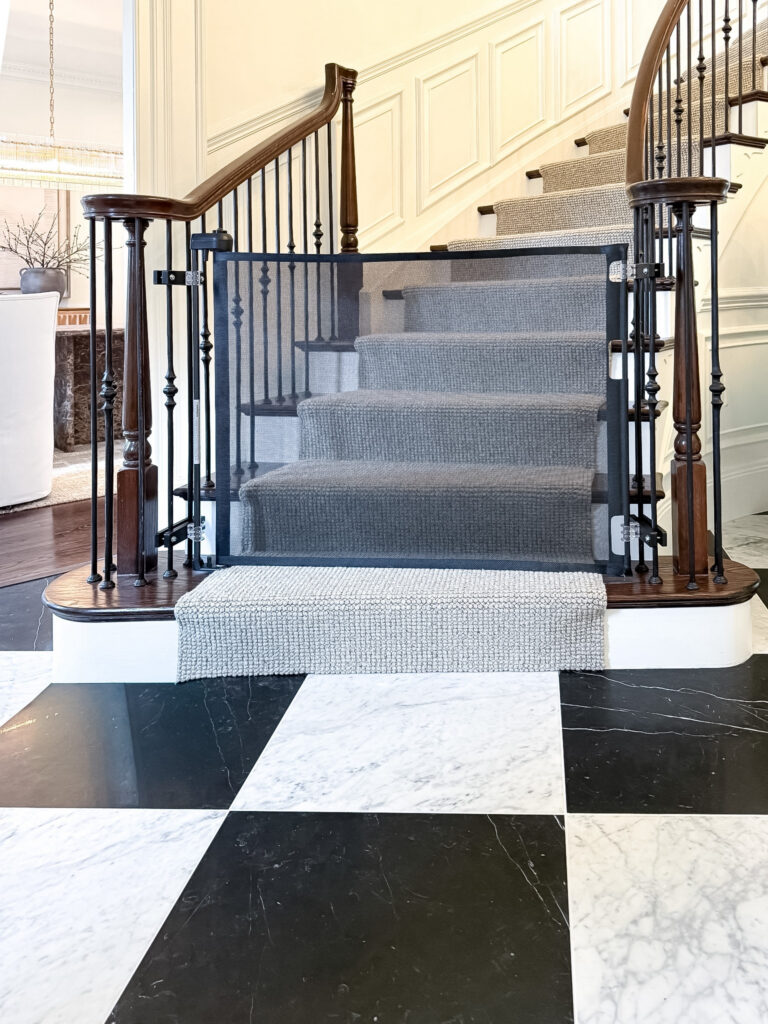 Black retractable gate across the foyer staircase in a maryland home