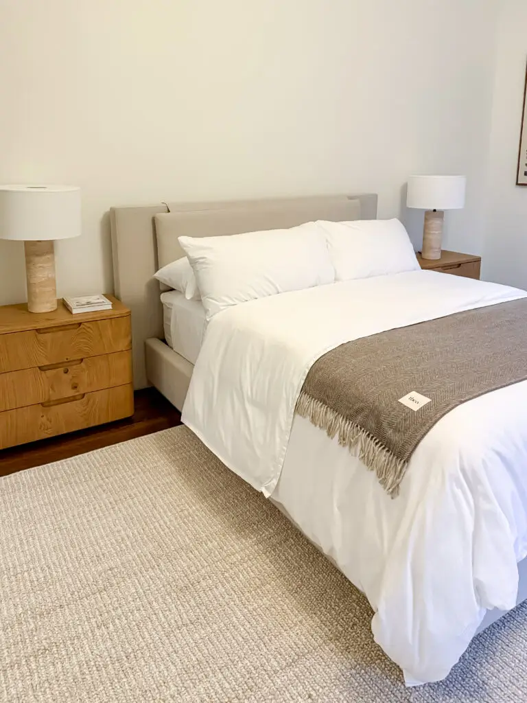 Guest bedroom with nightstands anchored to the wall with furniture straps in a maryland home