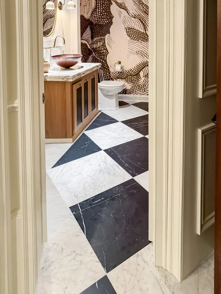 Bathroom with a latched wood vanity and marble checkerboard floor in a maryland home