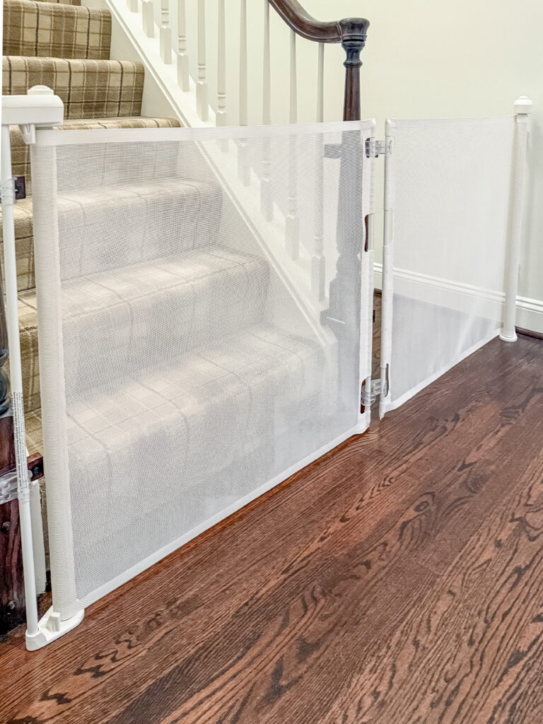 White retractable gates closed across the stairs to the third floor