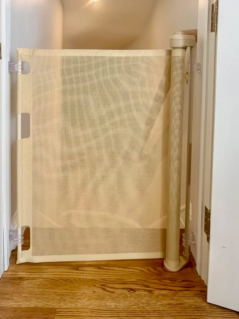 Cafe retractable gate closed across the top of the basement stairs in a forest hills, dc home