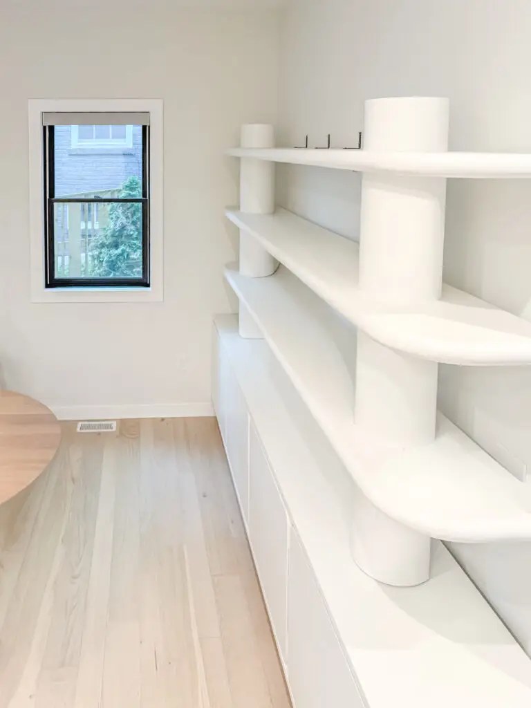 Curved built-in shelving in the play room of a forest hills, dc rowhouse